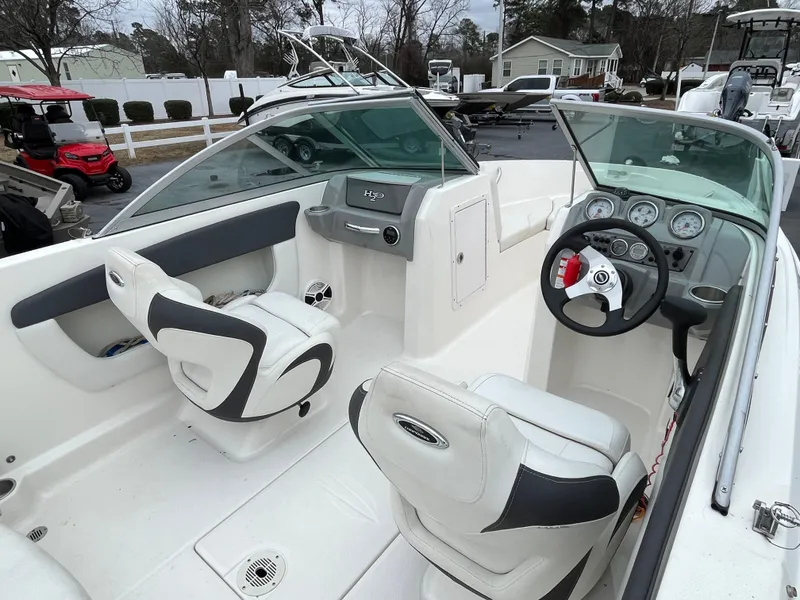 Slide: The Image of 2014 Chaparral 19 Sport H2O boat interior with steering wheel and seating. - 9