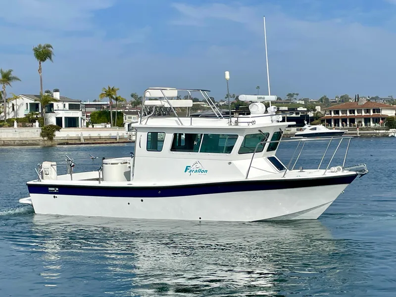 Slide: The Image of Farallon 2800 Whaleback boat, 2012 model, cruising in a scenic waterfront area. - 0