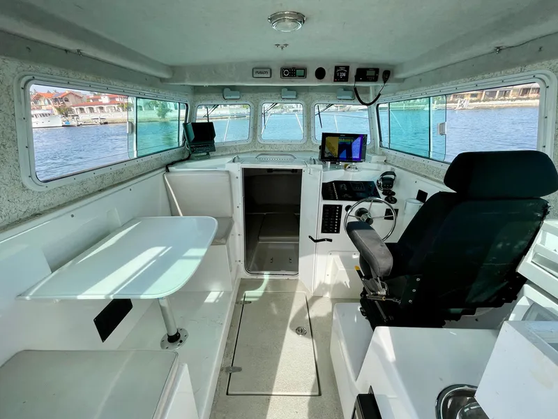 Slide: The Image of Interior of 2012 Farallon 2800 Whaleback boat with helm and seating area. - 10
