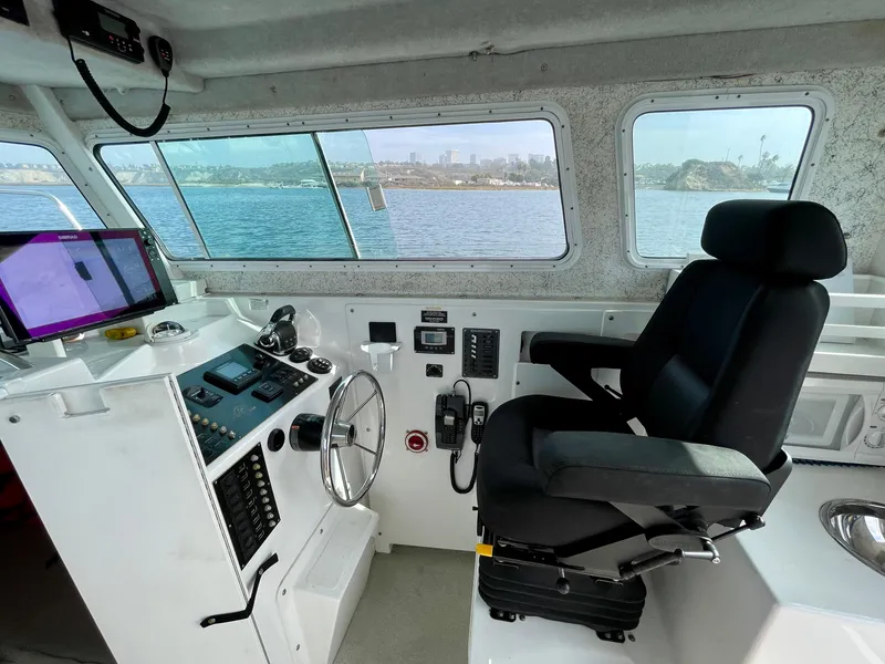 Slide: The Image of Interior of 2012 Farallon 2800 Whaleback boat, featuring helm station and captain's chair. - 11