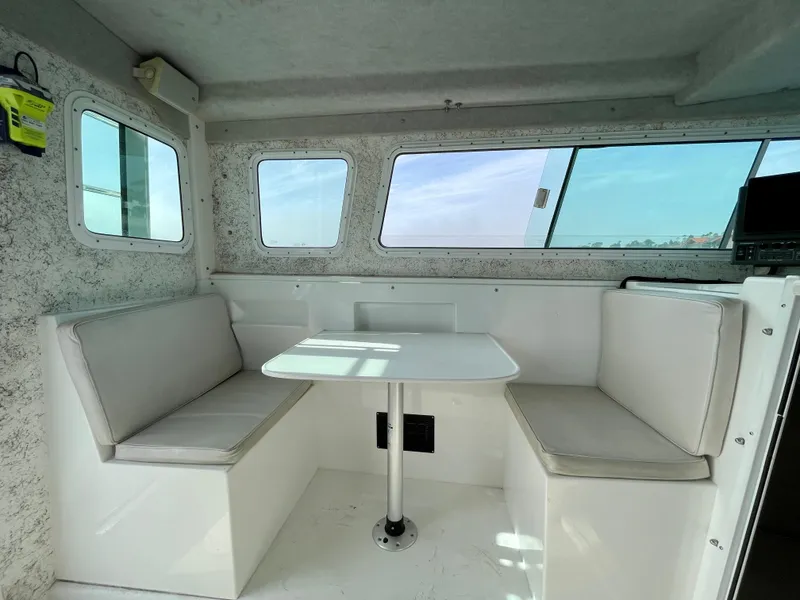 Slide: The Image of Interior of 2012 Farallon 2800 Whaleback boat with seating and table. - 13