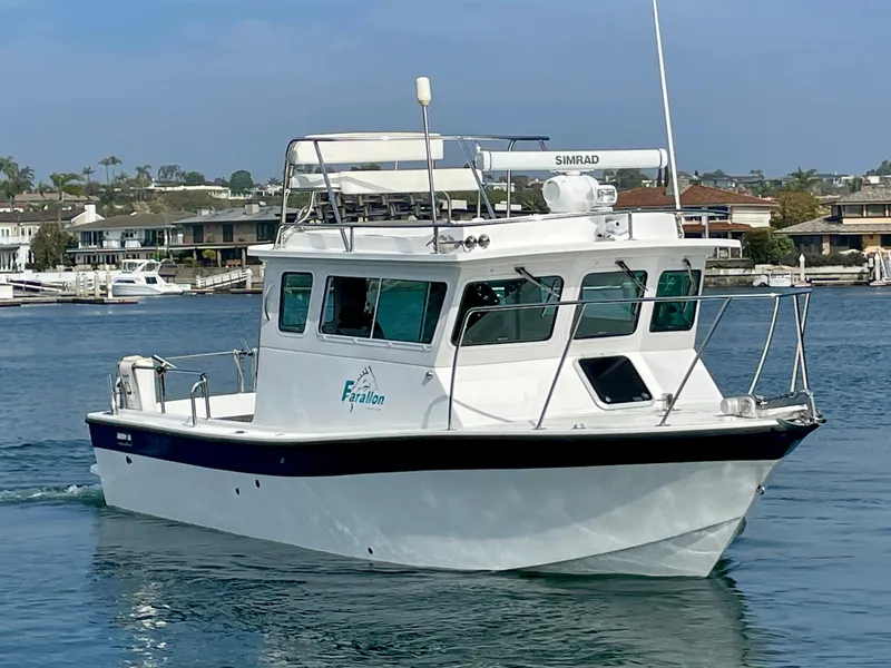 Slide: The Image of 2012 Farallon 2800 Whaleback boat cruising in a marina setting. - 4