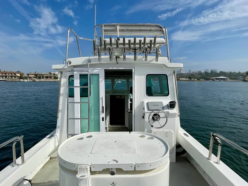 Slide: The Image of 2012 Farallon 2800 Whaleback boat on water, clear sky, rear view. - 5