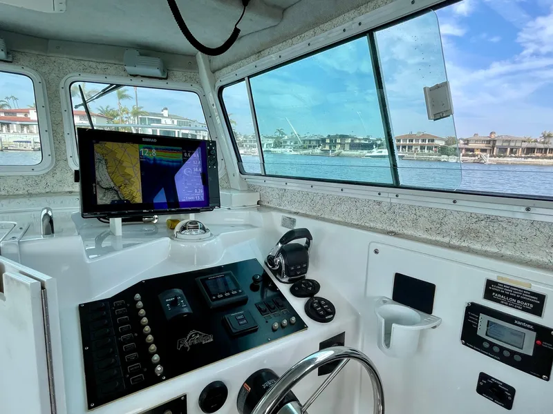 Slide: The Image of Interior view of 2012 Farallon 2800 Whaleback boat cockpit with navigation equipment. - 7