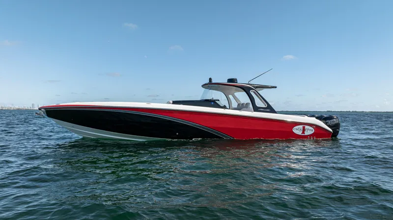 The Image of 2016 Cigarette 41 GTR boat on open water, featuring sleek red and black design. - 1