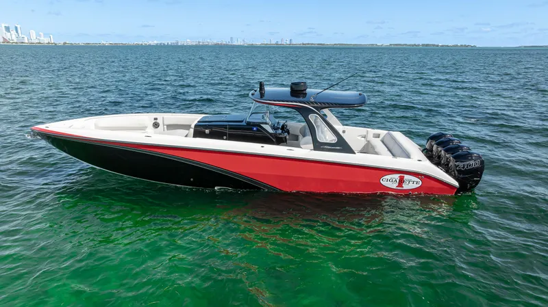 Slide: The Image of 2016 Cigarette 41 GTR boat on open water, featuring sleek red and black design. - 10