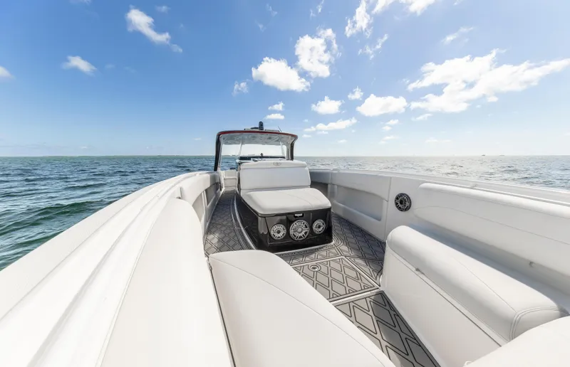 Slide: The Image of 2016 Cigarette 41 GTR boat interior with white seating, ocean view, and blue sky. - 21