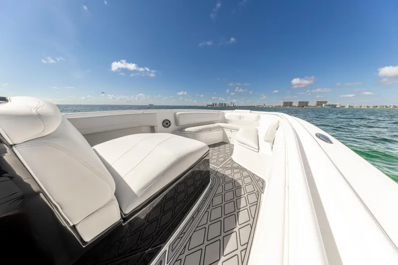 Slide: The Image of 2016 Cigarette 41 GTR boat interior with white seating, ocean view, and clear blue sky. - 23