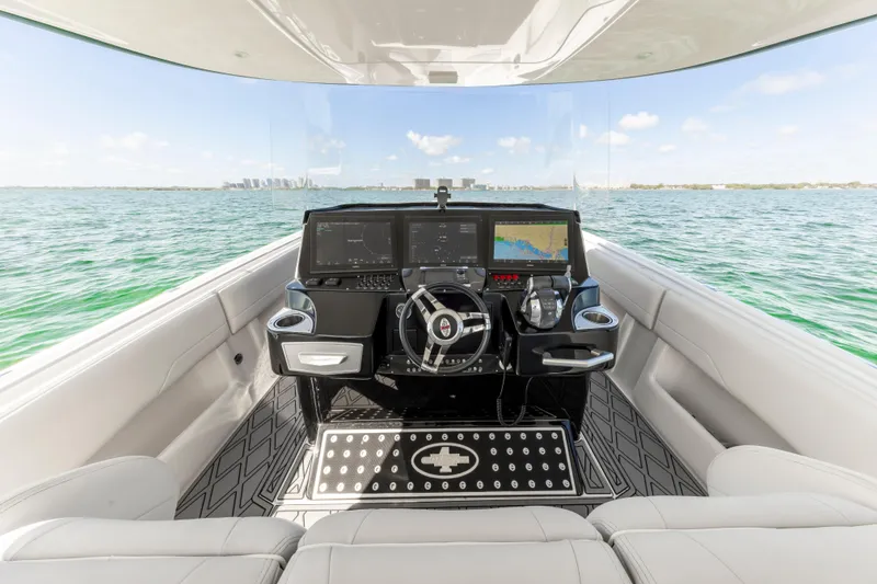 Slide: The Image of Interior view of 2016 Cigarette 41 GTR boat with modern dashboard and ocean backdrop. - 30