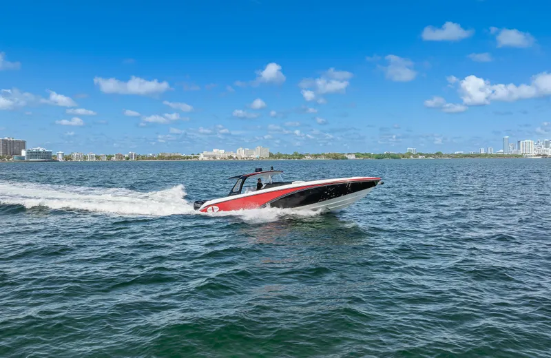 Slide: The Image of 2016 Cigarette 41 GTR speedboat cruising on open water under a clear blue sky. - 46