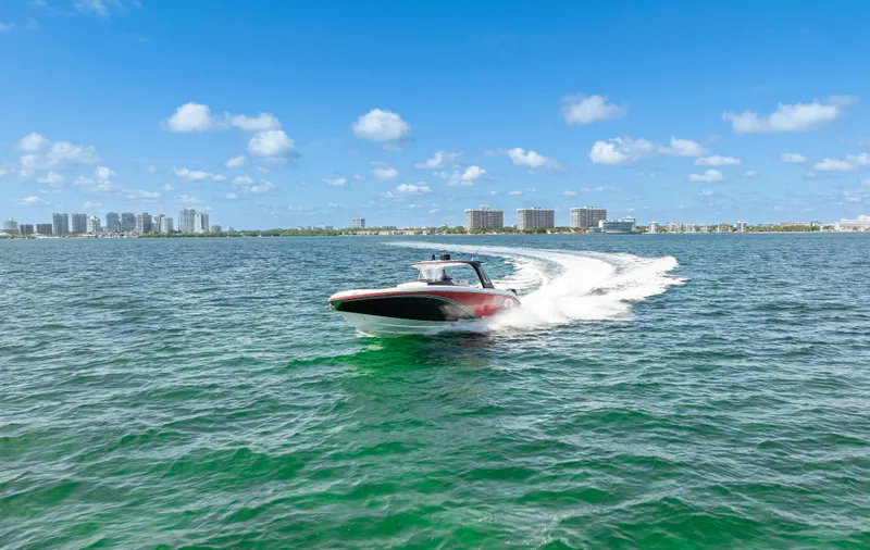 Slide: The Image of 2016 Cigarette 41 GTR speedboat cruising on open water under a clear blue sky. - 47