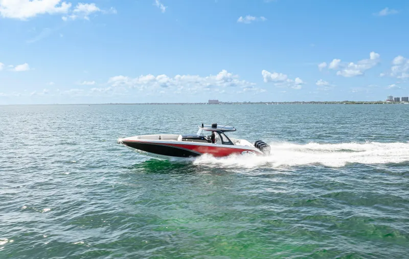 Slide: The Image of 2016 Cigarette 41 GTR speedboat cruising on open water under a clear blue sky. - 48
