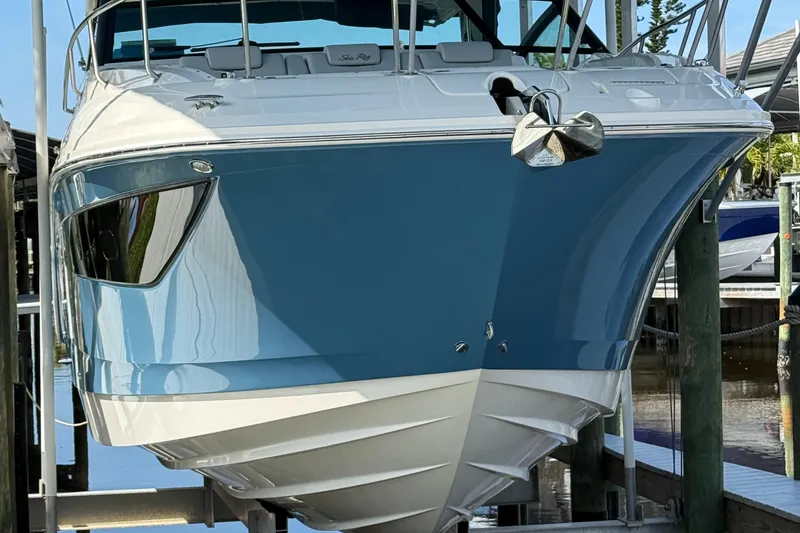 Slide: The Image of 2020 Sea Ray 32 Sundancer Outboard, blue hull, docked in marina. - 1