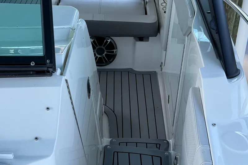 Slide: The Image of 2020 Sea Ray 32 Sundancer Outboard, sleek deck design with modern seating and speaker. - 13