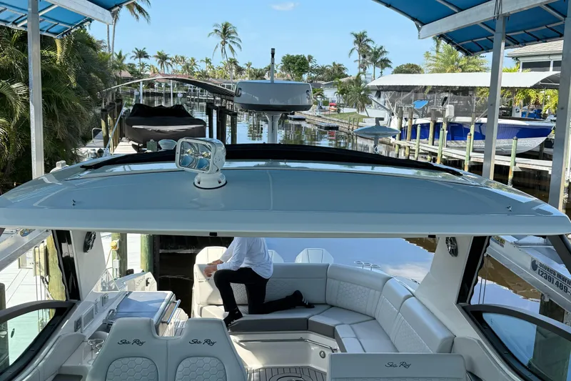 Slide: The Image of 2020 Sea Ray 32 Sundancer Outboard docked, featuring spacious seating and modern design. - 15