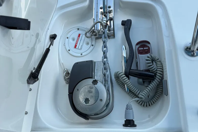 Slide: The Image of Anchor compartment of 2020 Sea Ray 32 Sundancer Outboard with winch and chain. - 16