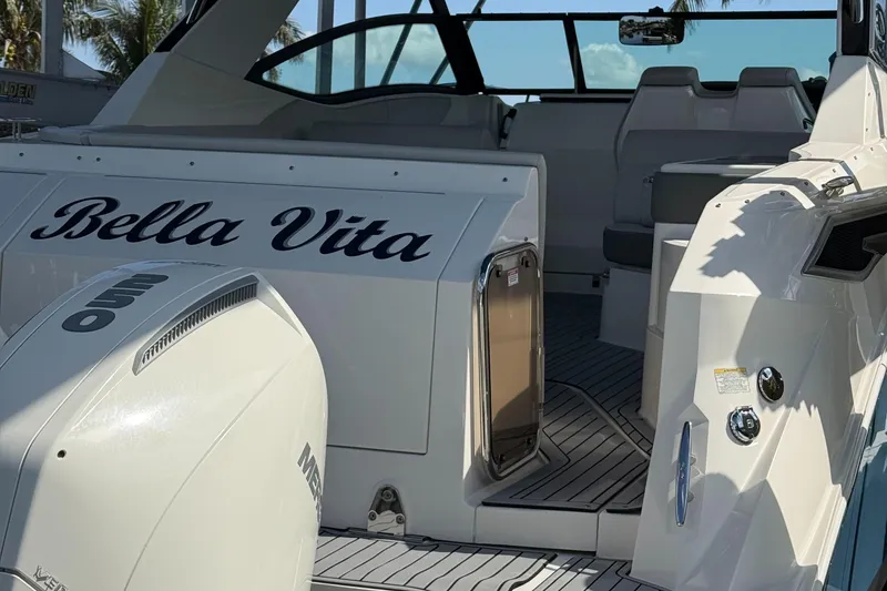 Slide: The Image of 2020 Sea Ray 32 Sundancer Outboard, "Bella Vita," with spacious deck and modern design. - 21