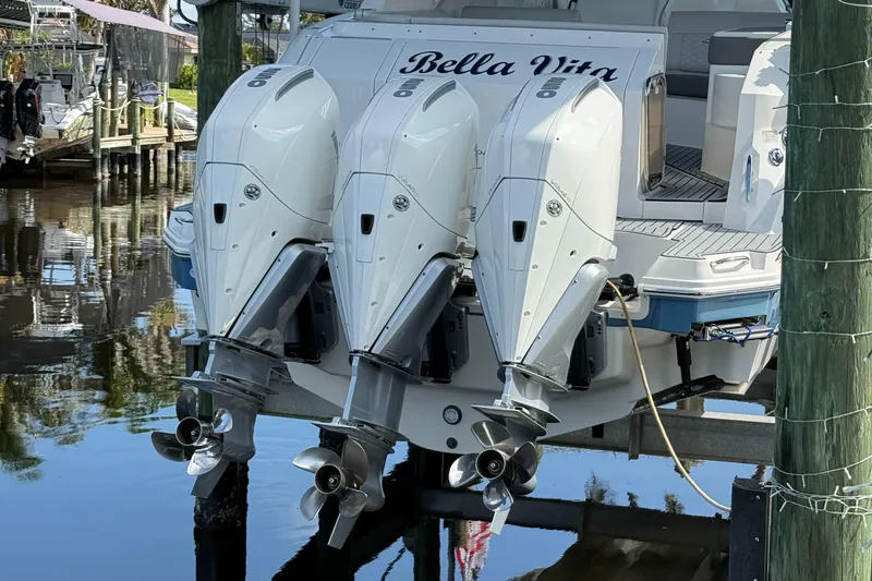 Slide: The Image of 2020 Sea Ray 32 Sundancer Outboard with triple engines, docked at marina. - 3