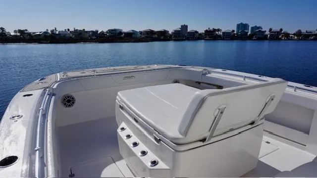 Slide: The Image of Invincible 35 Catamaran 2021, spacious deck seating, calm waters, coastal skyline in background. - 10