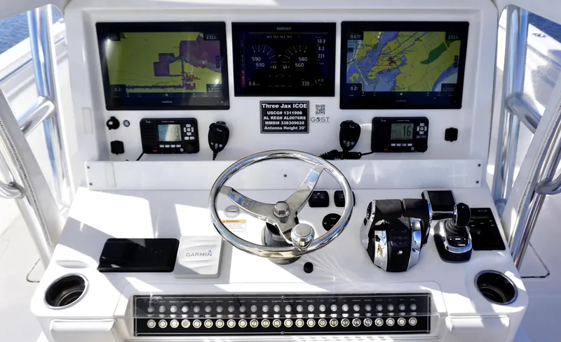 Slide: The Image of Control panel of 2021 Invincible 35 Catamaran with navigation screens and steering wheel. - 13
