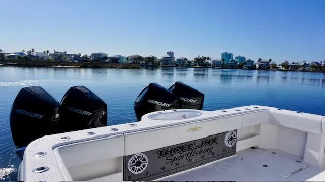 Slide: The Image of Invincible 35 Catamaran 2021 on calm water, featuring Mercury engines and sportfishing setup. - 17