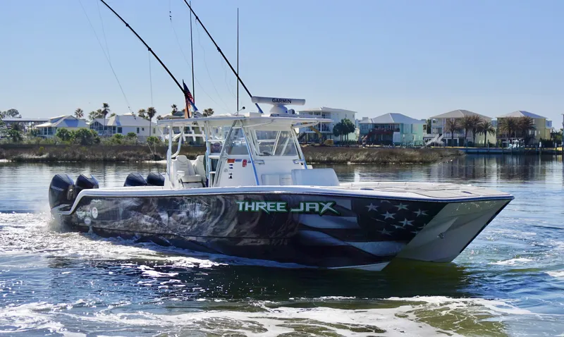 Slide: The Image of 2021 Invincible 35 Catamaran on water, featuring "Three Jax" design, with fishing rods. - 3
