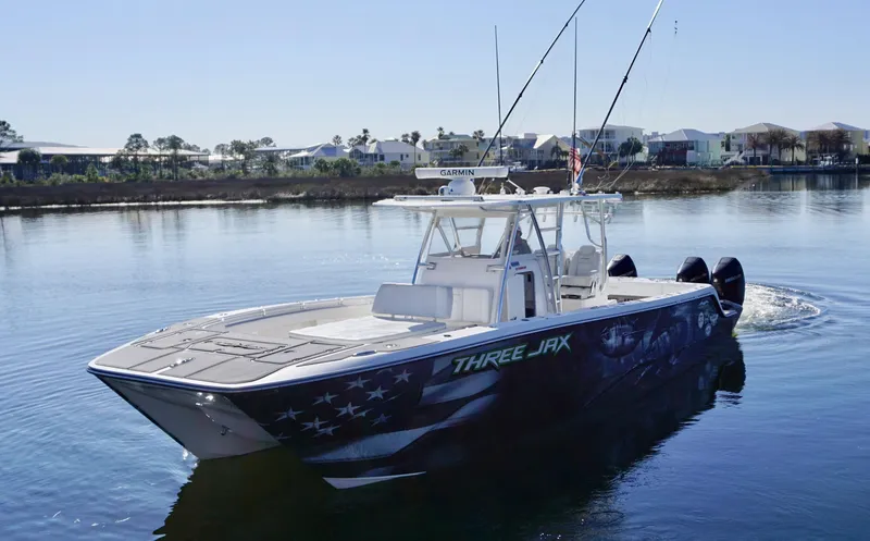 Slide: The Image of 2021 Invincible 35 Catamaran on calm water, featuring "THREE JAX" design. - 5