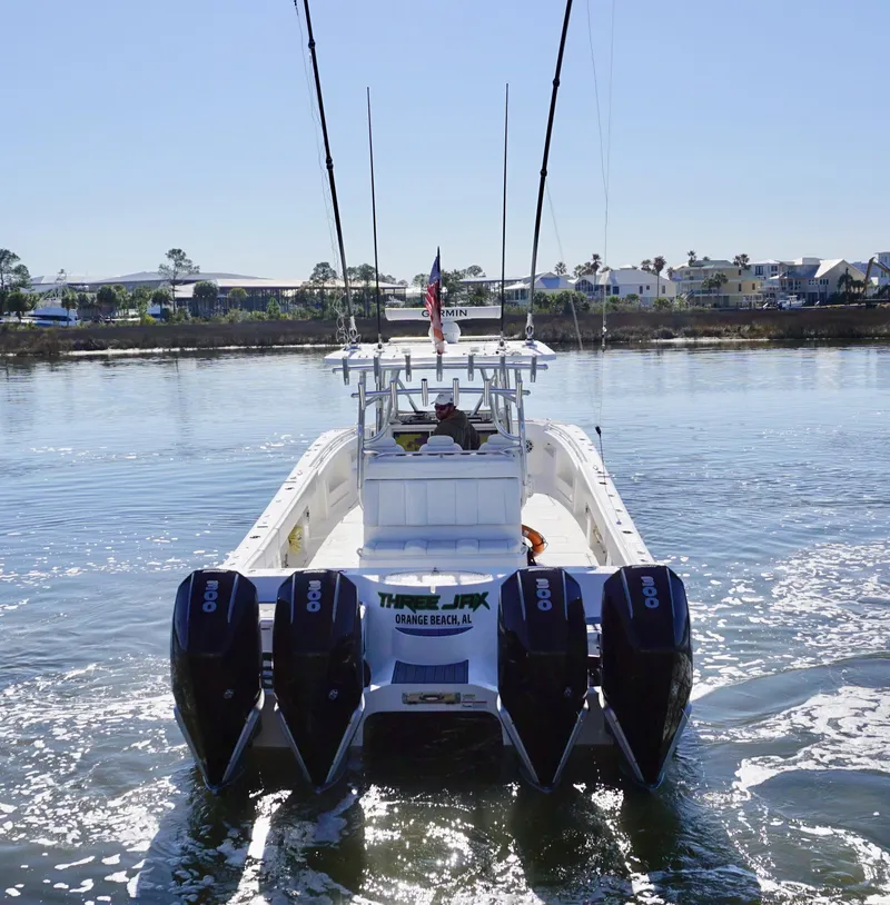 Slide: The Image of 2021 Invincible 35 Catamaran with four engines cruising on calm water. - 8