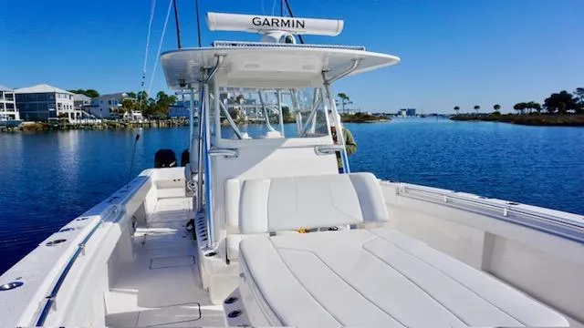 Slide: The Image of 2021 Invincible 35 Catamaran on calm water, featuring spacious deck and Garmin equipment. - 9