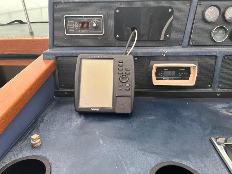 Slide: The Image of Control panel of a 1989 Sea Ray 390 Express Cruiser with gauges and steering wheel. - 11