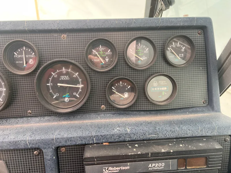 Slide: The Image of Dashboard of a 1989 Sea Ray 390 Express Cruiser with gauges and controls. - 13