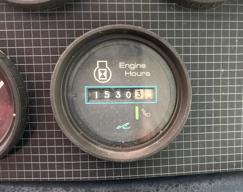 Slide: The Image of Dashboard of a 1989 Sea Ray 390 Express Cruiser with various gauges and controls. - 14