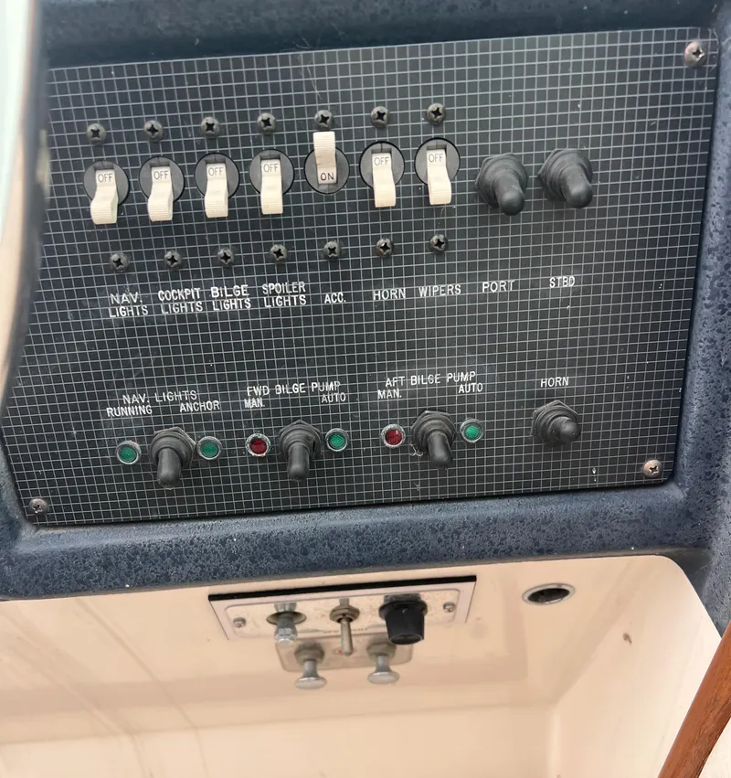 Slide: The Image of Control panel of a 1989 Sea Ray 390 Express Cruiser with spotlight and docking light switches. - 16