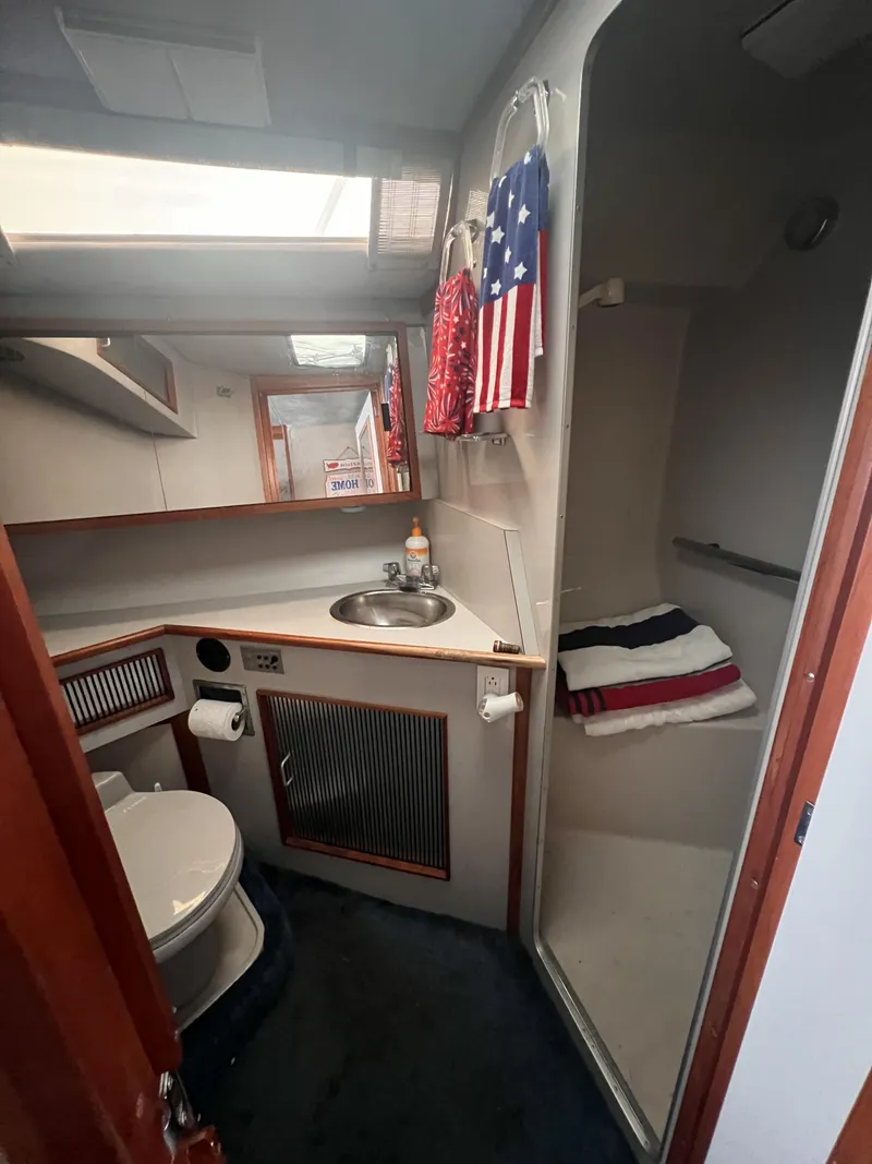 Slide: The Image of Interior cabin of 1989 Sea Ray 390 Express Cruiser with sink and bed. - 21
