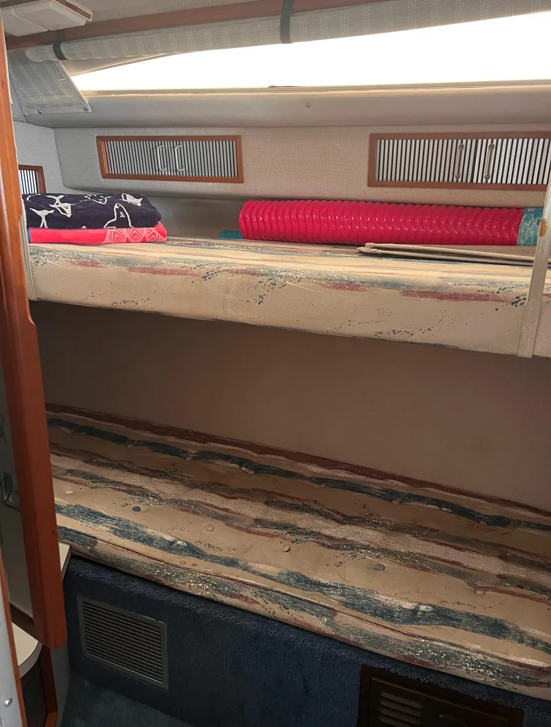 Slide: The Image of 1989 Sea Ray 390 Express Cruiser bathroom with sink, toilet, and shower area. - 22