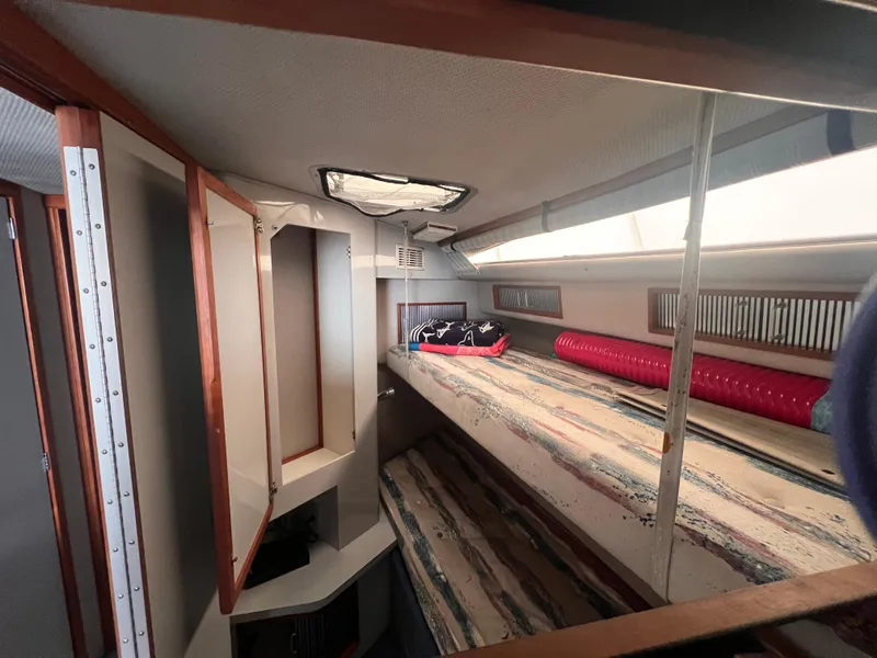 Slide: The Image of 1989 Sea Ray 390 Express Cruiser cabin with bunk beds and nautical decor. - 23