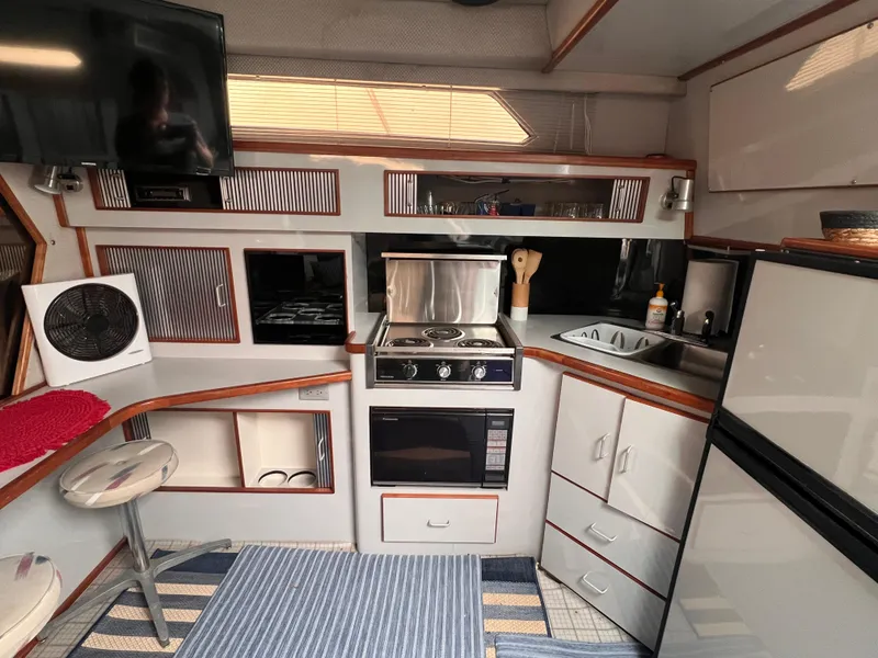 Slide: The Image of Interior cabin of 1989 Sea Ray 390 Express Cruiser with bunk beds and storage. - 24