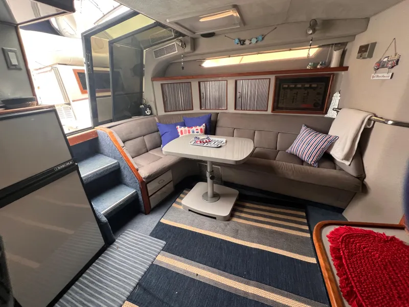 Slide: The Image of Interior of 1989 Sea Ray 390 Express Cruiser with kitchen and modern amenities. - 26