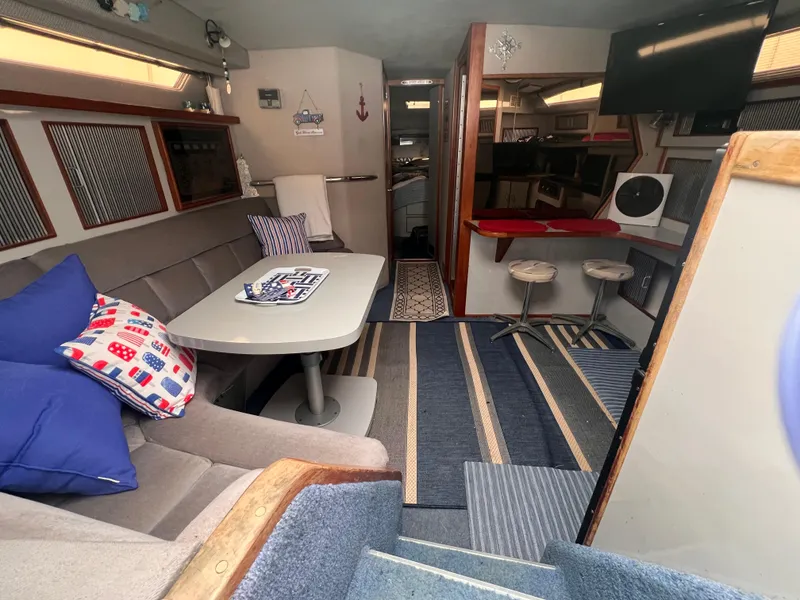 Slide: The Image of Interior of 1989 Sea Ray 390 Express Cruiser with cozy seating and dining area. - 27