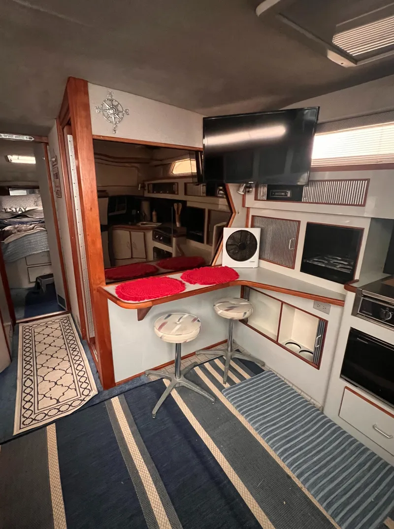 Slide: The Image of 1989 Sea Ray 390 Express Cruiser kitchen with stove and microwave. - 30