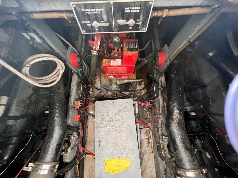 Slide: The Image of Engine compartment of a 1989 Sea Ray 390 Express Cruiser with visible wiring and components. - 32