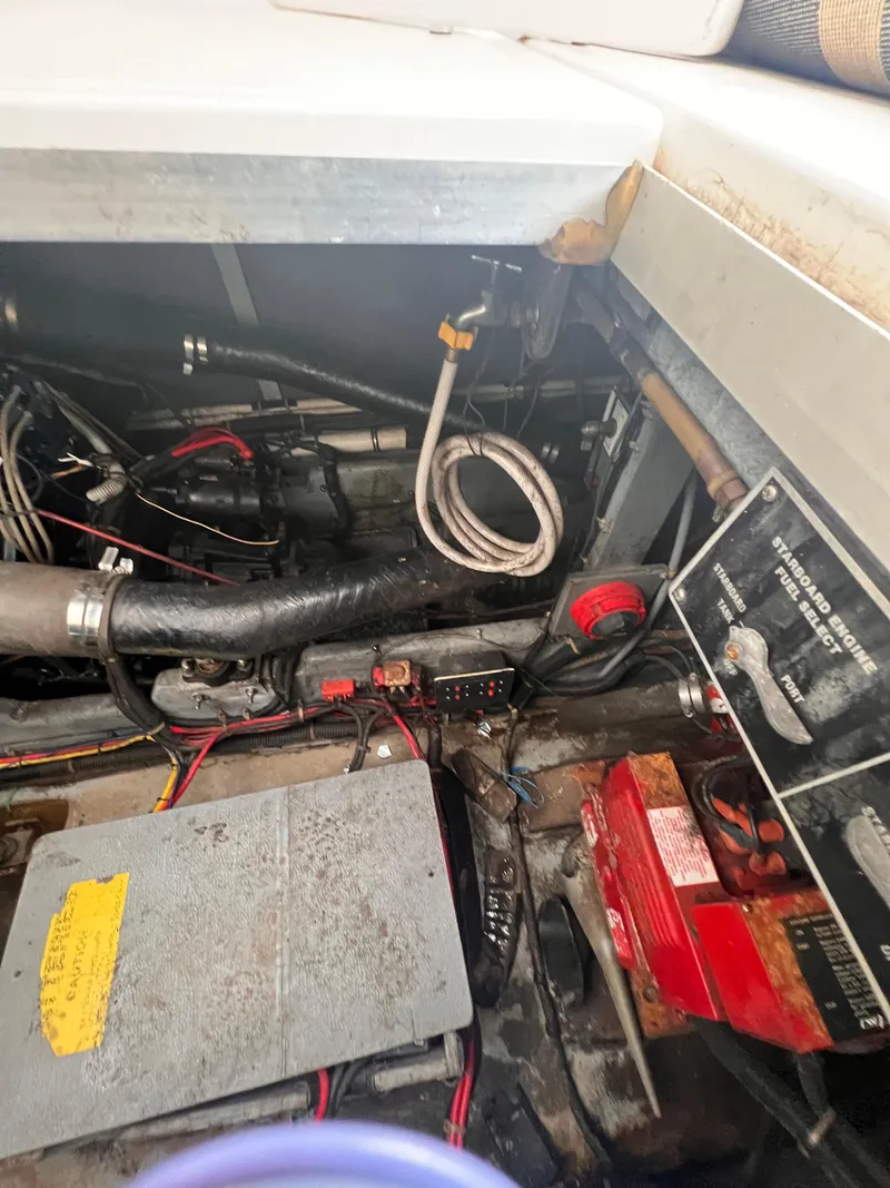 Slide: The Image of Engine room of 1989 Sea Ray 390 Express Cruiser with visible wiring and components. - 33
