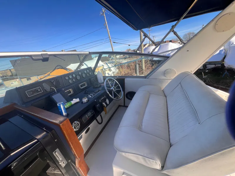 Slide: The Image of 1989 Sea Ray 390 Express Cruiser interior with ocean view and seating area. - 6