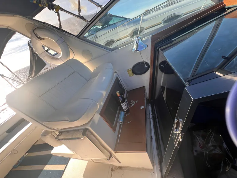 Slide: The Image of 1989 Sea Ray 390 Express Cruiser cockpit with steering wheel and seating. - 7