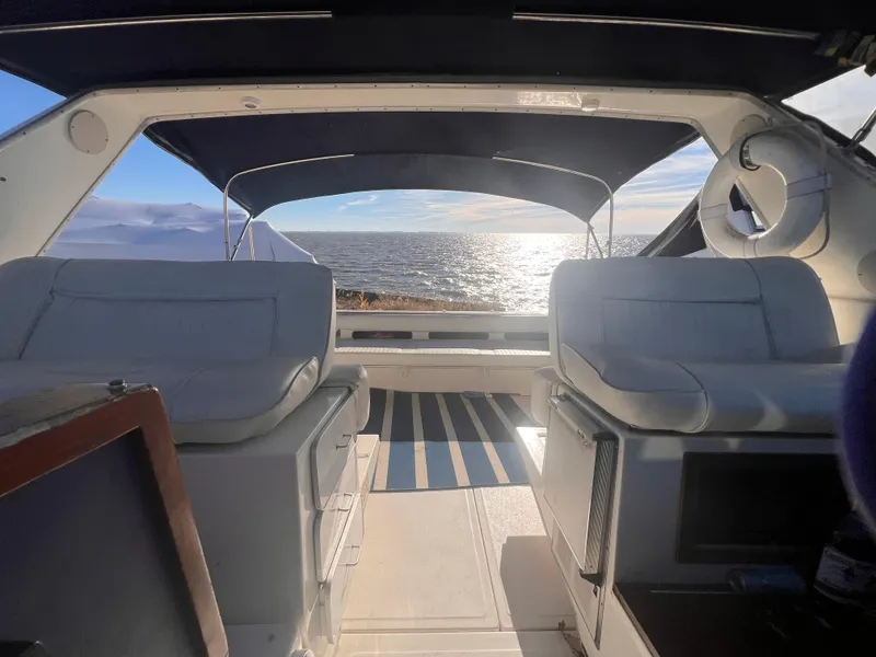 Slide: The Image of 1989 Sea Ray 390 Express Cruiser interior with seating and control panel. - 8