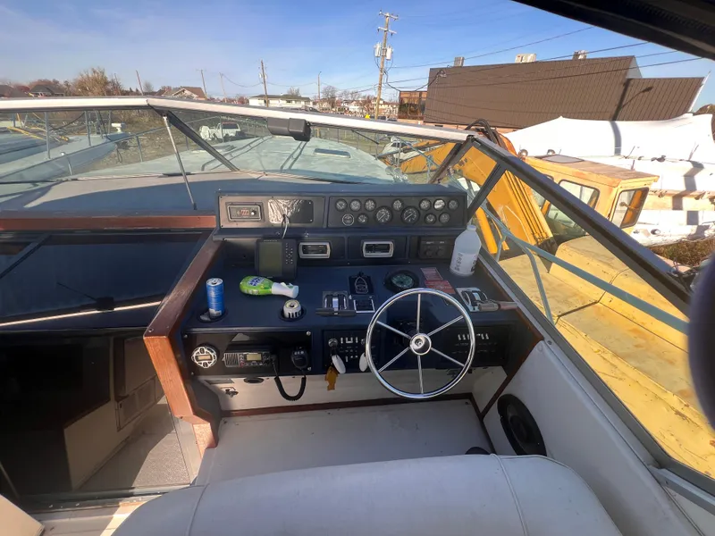 Slide: The Image of 1989 Sea Ray 390 Express Cruiser interior with ocean view and seating. - 9