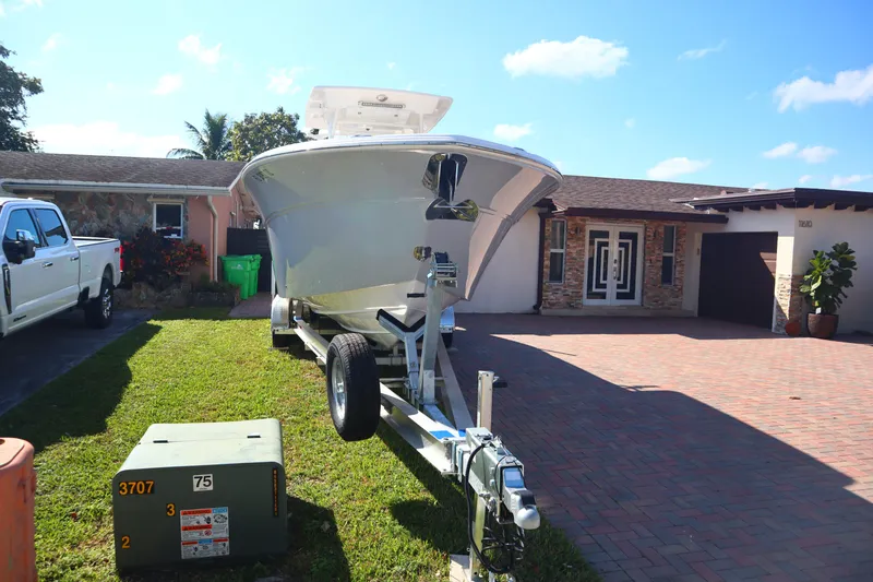 The Image of 2022 Sea Fox 288 Commander boat on trailer in residential driveway. - 1
