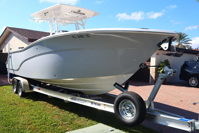 Slide: The Image of 2022 Sea Fox 288 Commander boat on trailer, parked in residential driveway. - 2