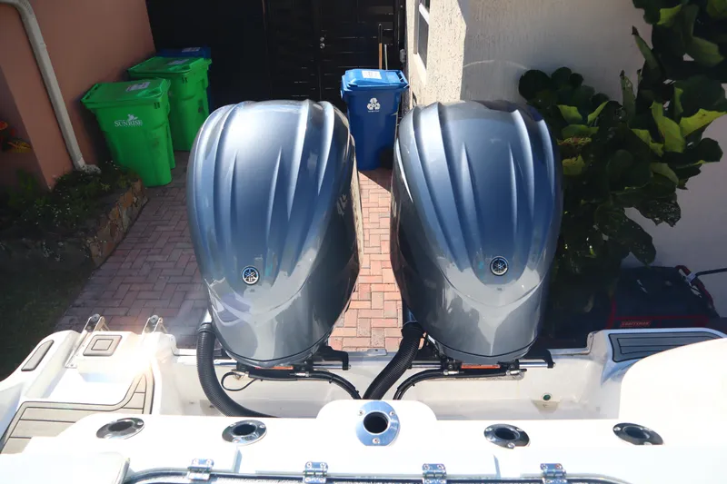 Slide: The Image of Twin outboard motors on a 2022 Sea Fox 288 Commander boat, parked in a driveway. - 27