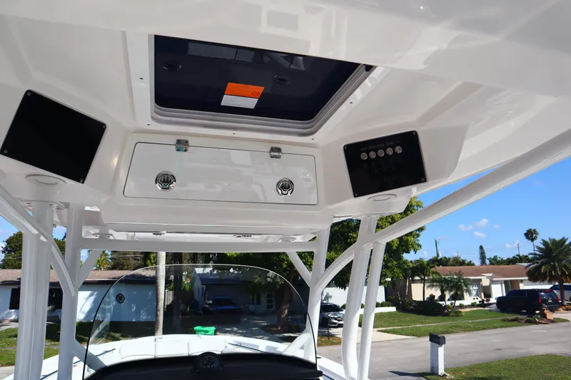 Slide: The Image of 2022 Sea Fox 288 Commander boat console with overhead storage and controls. - 29